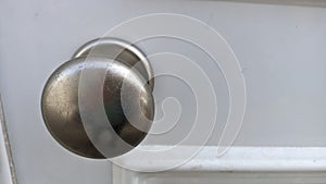 Metal chrome handle on white wooden door