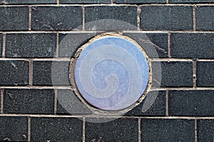 Metal circle on brick background