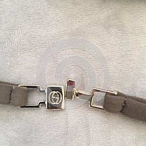 Metal clasp on Gucci swimsuit with logo