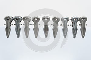 Metal clothespin on white background