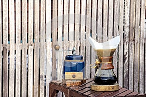 Metal coffee grinder and drip glass pitcher