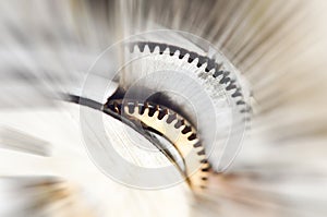 Metal Cogwheels in clock mechanism , abstract sun beams. Macro