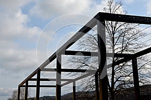 Metal construction of the bus stop, gazebo pergola shelter. the roof and walls are braided with a rope net for climbing plants. is