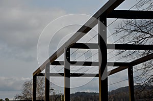 Metal construction of the bus stop, gazebo pergola shelter. the roof and walls are braided with a rope net for climbing plants. is