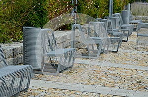 From metal constructions to climbing plants and vines is a sitting terrace of rough stone paving chipped cubes. metal gray furnitu