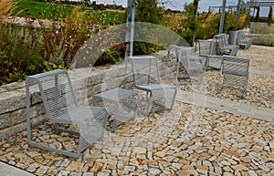 From metal constructions to climbing plants and vines is a sitting terrace of rough stone paving chipped cubes. metal gray furnitu