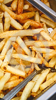 Metal container with lots of fried potatoes