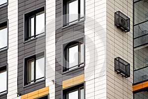 Metal containers for individual air conditioner on facade of apartment building. Exterior finishing of modern