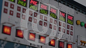 Metal control panel with many buttons, lights, switches on Industrial equipment. Closeup