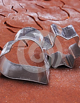 Metal cookie cutters and dough for gingerbread