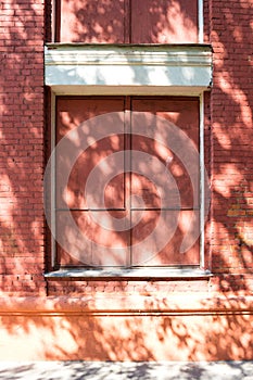 Metal-covered window in an old brick house