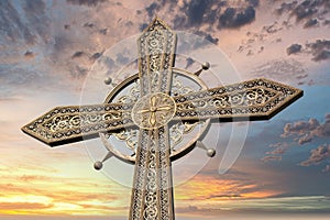 Metal cross against dramatic sky. Kamianets-Podilskyi, Ukraine