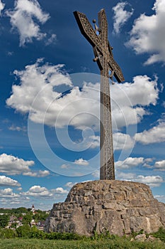 Metal cross in front of castle in Kamianets-Podilskyi, Ukraine