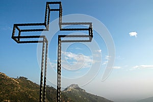 Metal cross of the viewpoint of the desert of palms photo