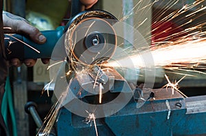 Metal cutting with a grinding machine with sparks.