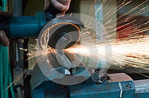 Metal cutting with a grinding machine with sparks.