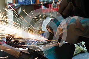 Metal cutting with a grinding machine with sparks.