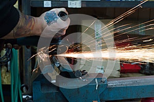 Metal cutting with a grinding machine with sparks.