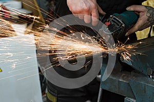 Metal cutting with a grinding machine with sparks.