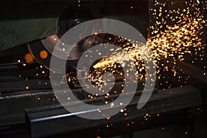 Metal cutting. Sparks from processing a metal profile.