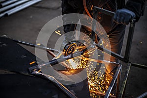 Metal cutting. Sparks from processing a metal profile.