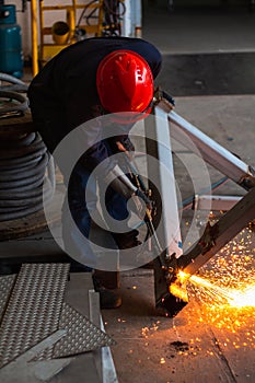 Metal cutting, steel with acetylene torch in factory. wear protective gloves when working with fire flakes