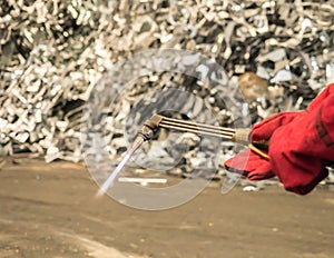 Metal cutting torch with soot and flame in recycle factory, Thai