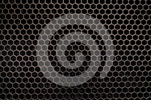 metal dark gray surface hexagonal holes. background texture for desktop wallpaper, screensaver. Bullet holes. Industrial