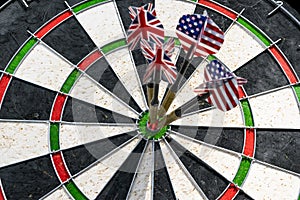 Metal darts have hit the red bullseye on a dart board. Darts Gam