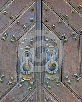 Metal decorated old solid wood door closeup