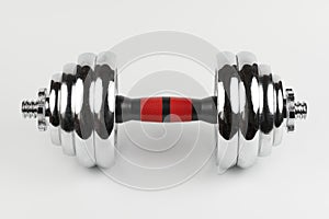 Metal demountable dumbbell with black plates and red handle isolated