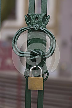 Metal design lock on iron entrance gate padlock.