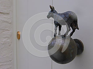 Metal donkey on metal doorknob