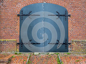 Metal door in a brick wall photo