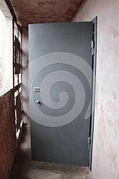Metal door of grey colour on balcony