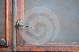 Metal door handle on old cabin door with copy space,