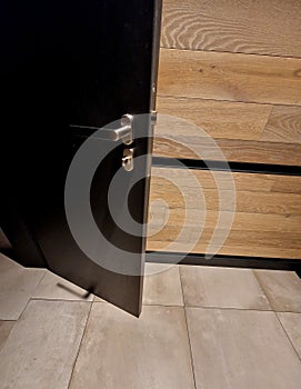 metal door handle by toilet with lower ventilation