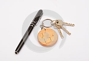 Metal door keys with pen and key ring isolated on white background