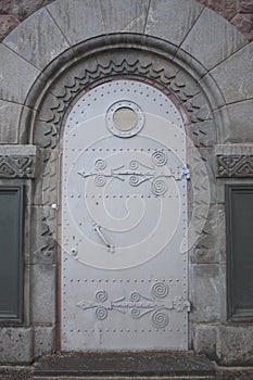 Metal door with an nautical porthole window