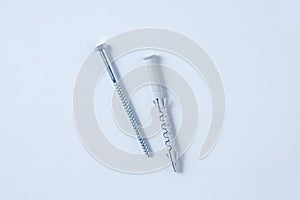 Metal dowel nail with plastic box on a white background