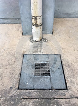 Metal drain cover on the cement floor