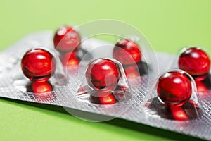 Metal drug blister with red medicine capsules