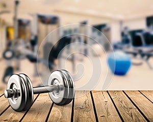 Metal dumbbell with gym background