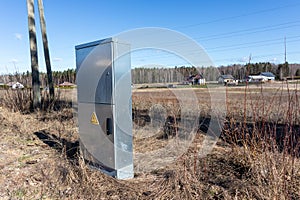 Metal electrical distribution box on field background