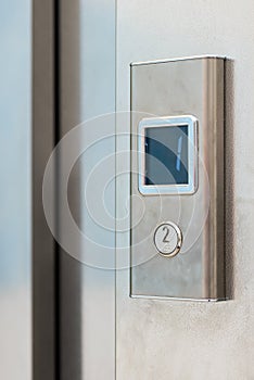 Metal elevator button with electronic display