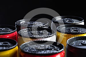 metal energy drinks cans on black background with copy space