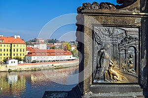 Metal engraving of a warrior with a dog with an old building on the background and river