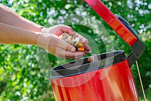 Metal espresso coffee capsules put in the trash with greeny background