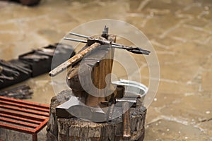 A metal fabricator utilizing a torch to heat up a piece of metal in order to shape it utilizing a forging technique