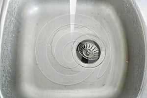 Metal faucet with water flowing